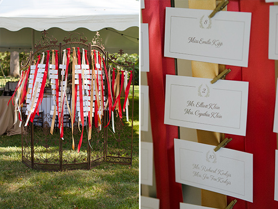 Elegant wedding seating chart display with red ribbons