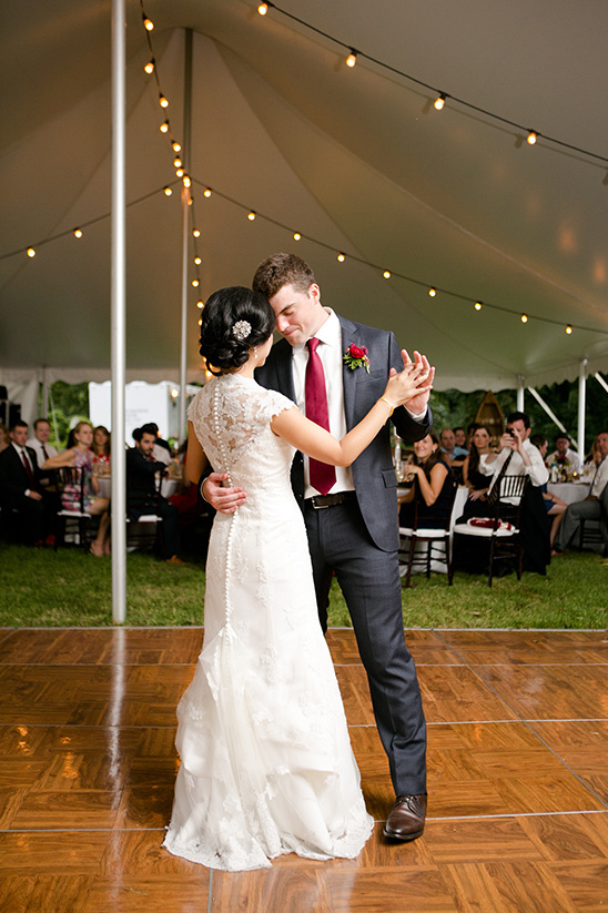 Bride and groom first dance under tent lights