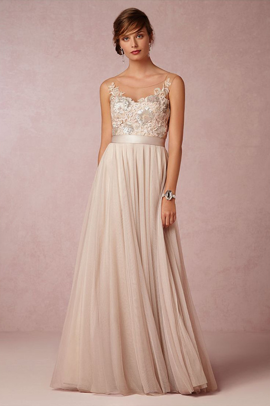Elegant woman wearing a beautiful beige embellished wedding dress