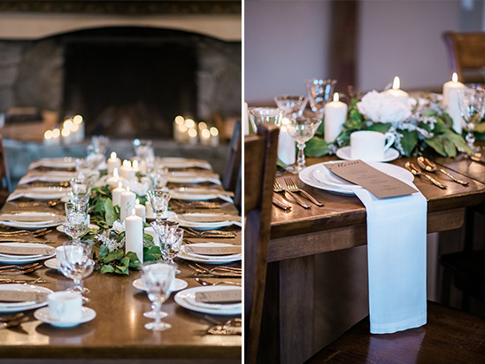 Elegant rustic table setting with candles and greenery
