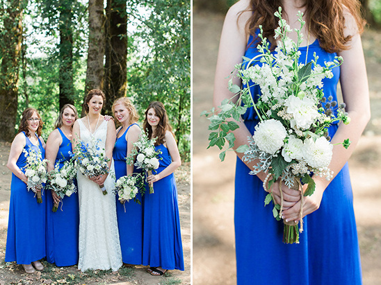 Bridesmaids in blue dresses with bouquets in a forest setting