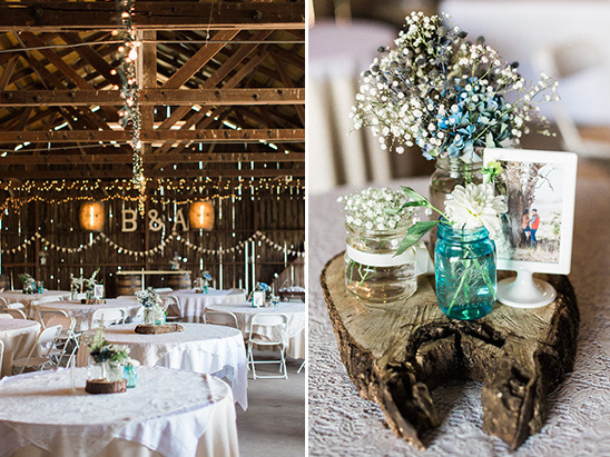 Rustic barn wedding reception decor with floral centerpieces