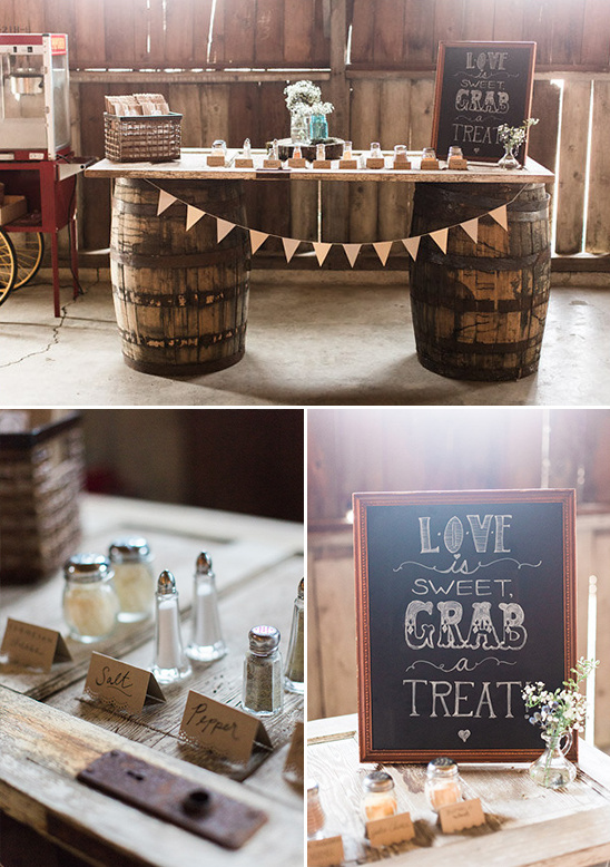 Rustic wedding dessert table with barrels and chalkboard sign