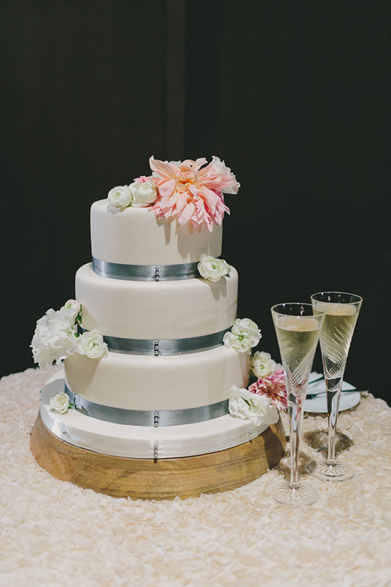 white pink and blue wedding cake by The Cakery @weddingchicks
