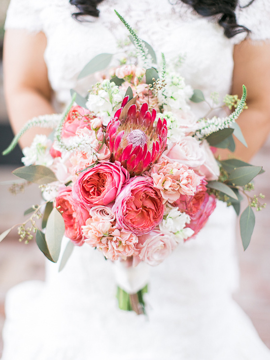 Bride holding a gorgeous pink and red floral wedding bouquet