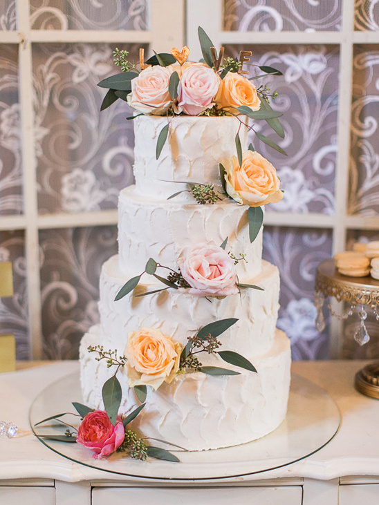 Four-tiered wedding cake with flowers for a beautiful celebration