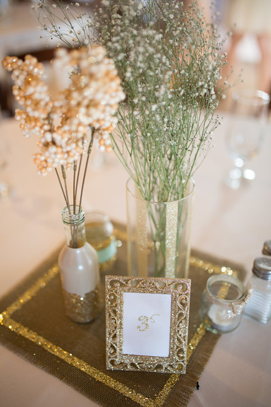 Elegant table decor with gold frame and floral centerpieces