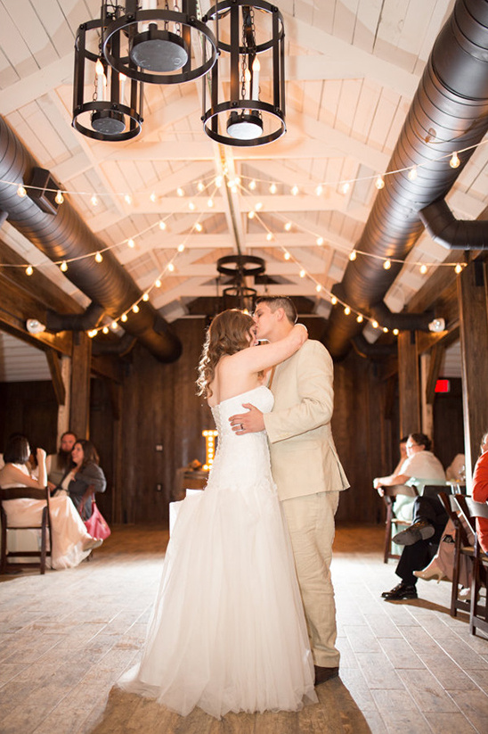 Bride and groom sharing a kiss during their wedding dance