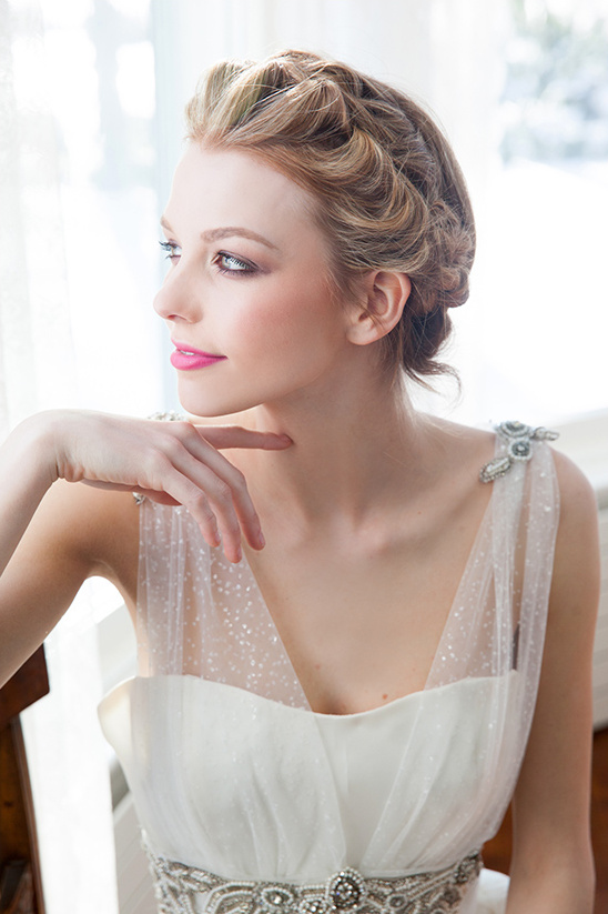 Elegant bride with updo hairstyle and wedding dress