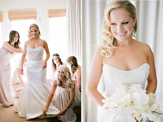 Bride smiling while getting ready with bridesmaids for wedding