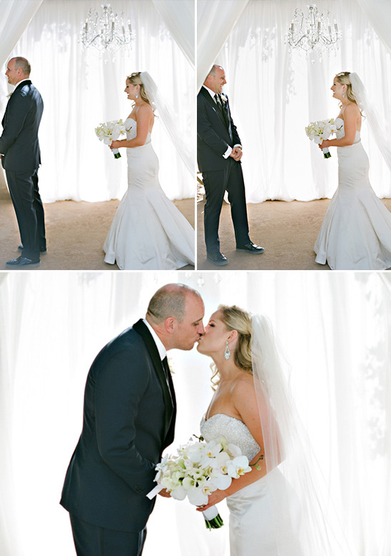 Bride and groom share a sweet first kiss on their wedding day