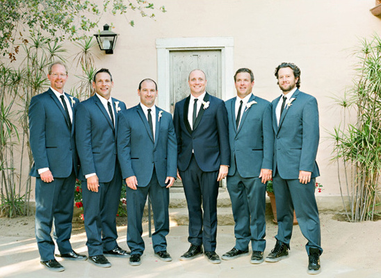 Groomsmen in stylish blue suits posing for a wedding photo