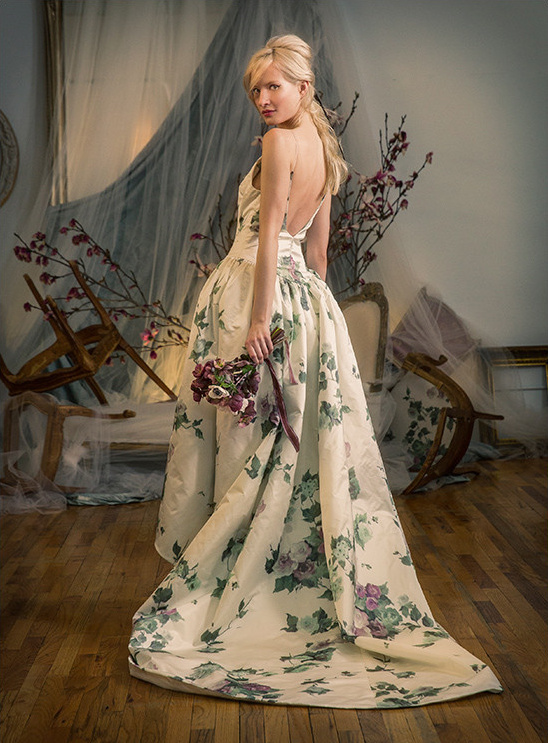 Elegant bride in floral wedding gown, looking over her shoulder
