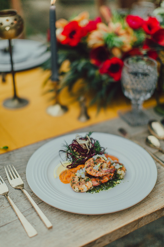 Grilled shrimp entree on plate at festive dinner table