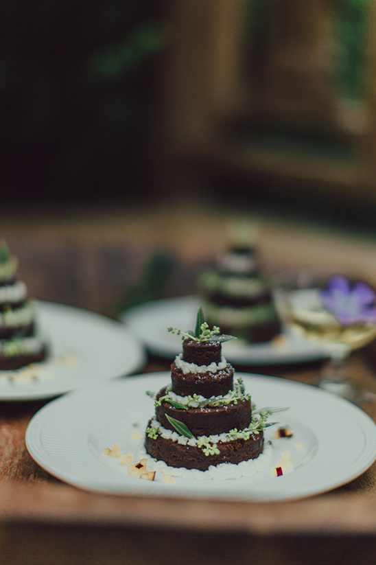 Mini chocolate layer cakes decorated with greenery