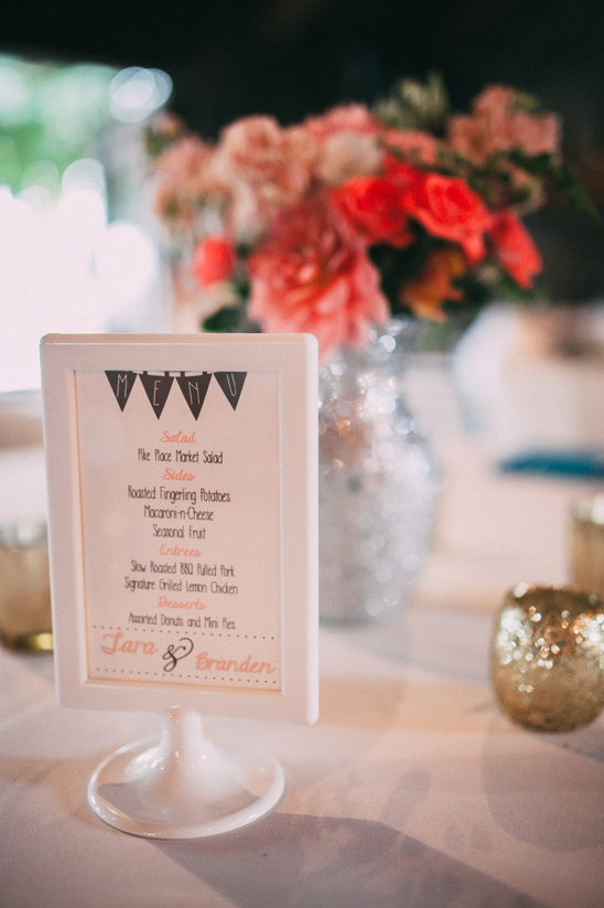 Wedding menu at a reception, with floral arrangement background