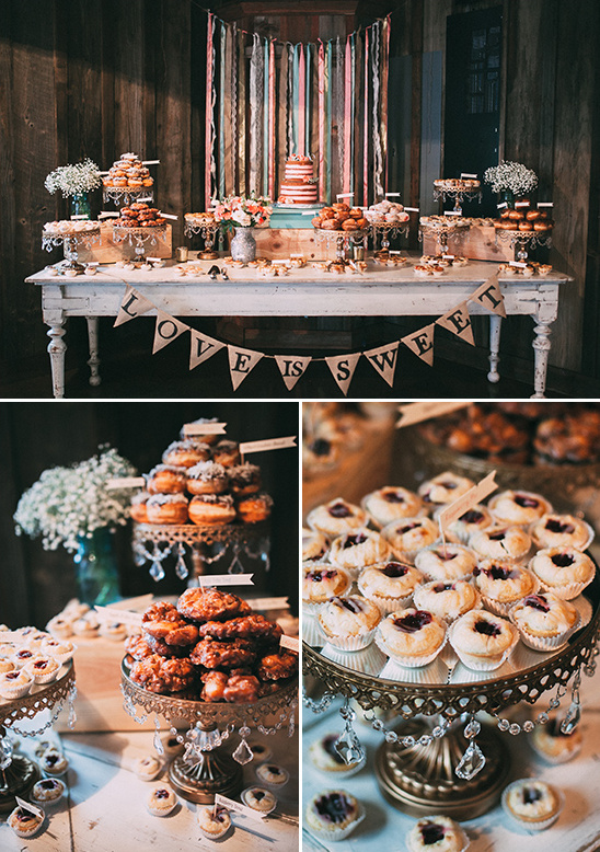 Wedding dessert table with donuts and cake and the love is sweet banner