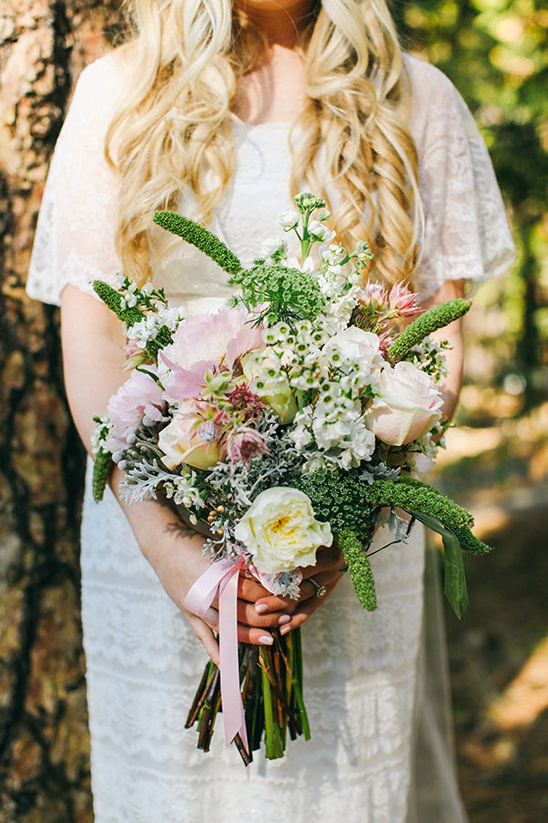 Bride in white dress holding a beautiful wedding bouquet