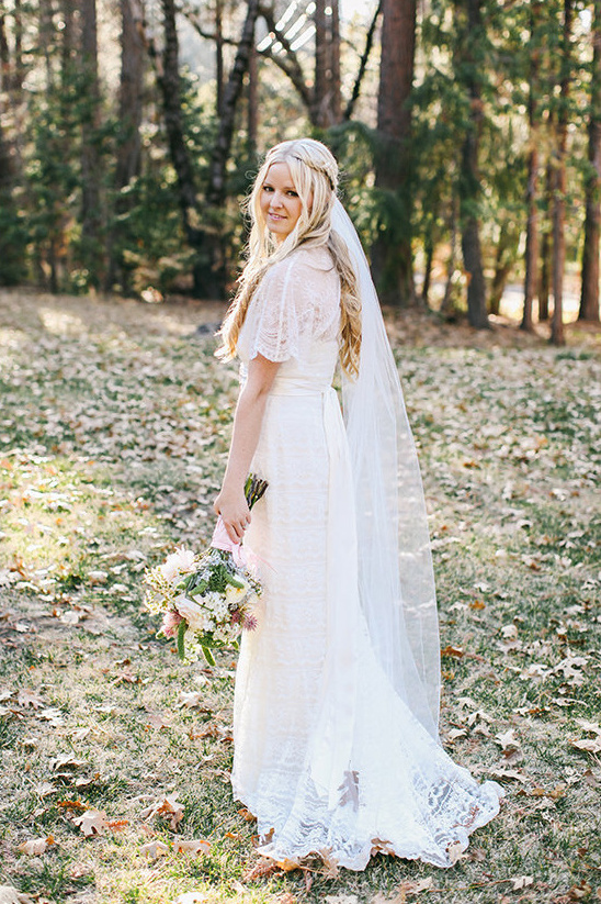 Beautiful bride in elegant wedding dress holding bouquet