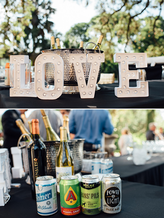 Wedding bar setup with LOVE sign, beer cans and wine bottles