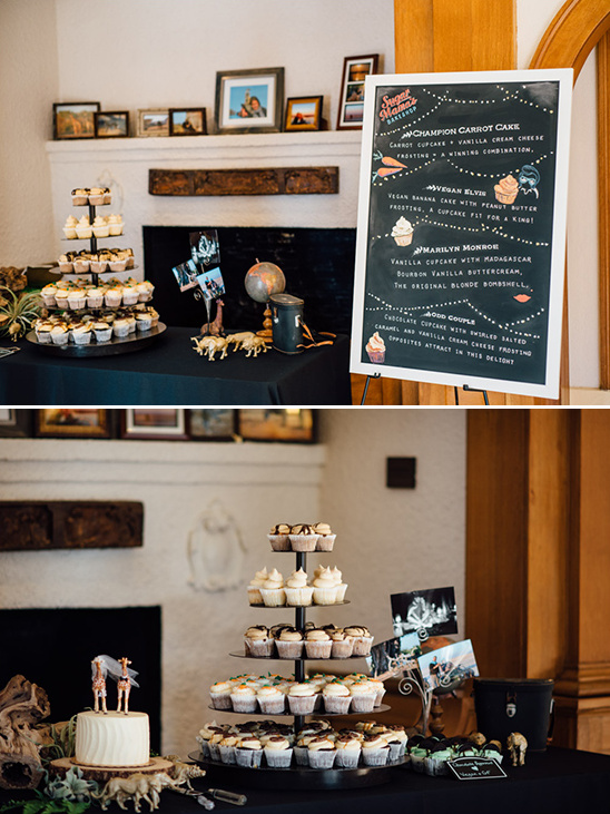 Cupcakes on display with wedding cake and decorative menu sign