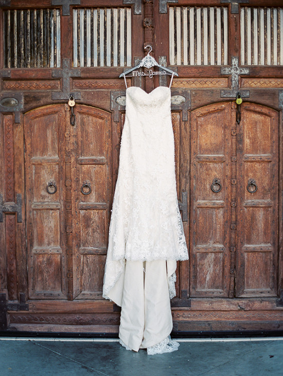Strapless lace wedding gown on rustic wooden doors