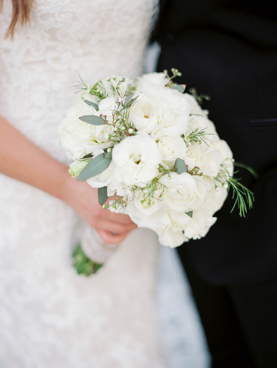 Bride holding a stunning white wedding bouquet of flowers