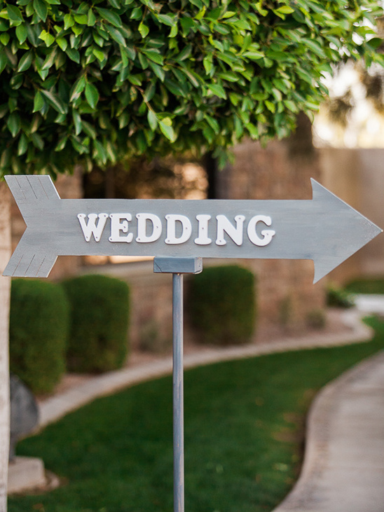 Wedding sign pointing to the ceremony on a sunny day outdoors