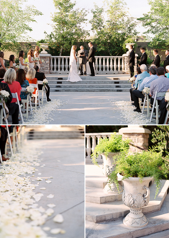 Outdoor wedding ceremony with rose petals and greenery decorations