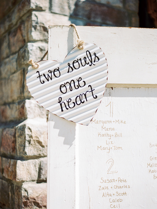 Wedding decor with heart-shaped sign saying two souls one heart