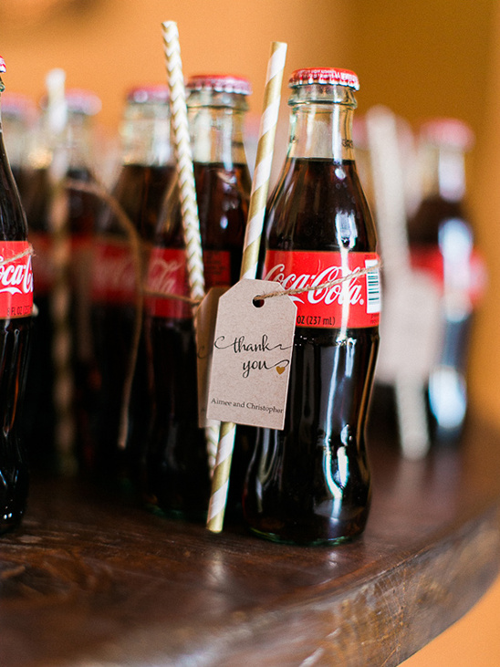 Coca Cola bottles with a thank you tag and striped straws