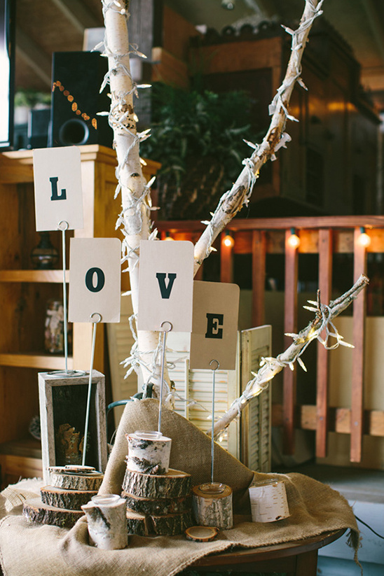 Rustic wedding decor with the word LOVE in cards on the table