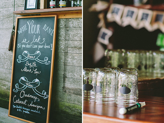 Chalkboard sign with drink options and glasses at a wedding reception