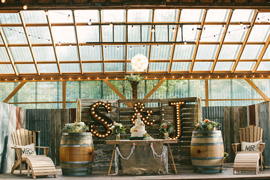 Rustic wedding reception venue with cake and decor