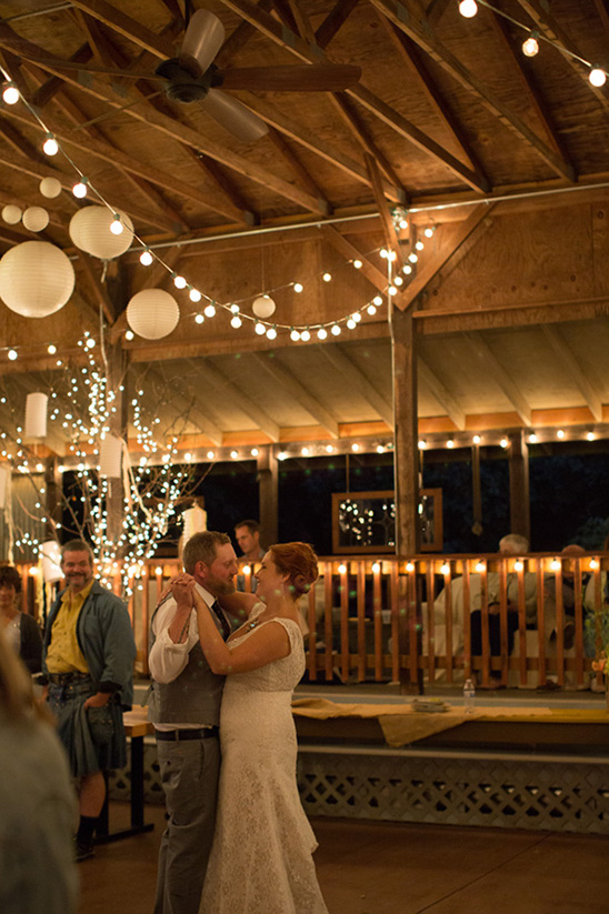Bride and groom share a romantic dance at an outdoor wedding