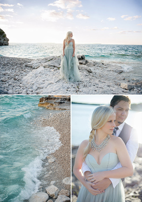 Couple poses for engagement photos on rocky ocean beach