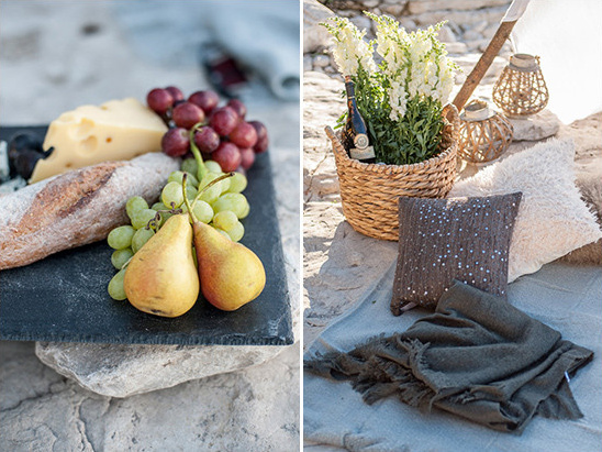 Elegant picnic on rocks with cheese fruit platter and decor