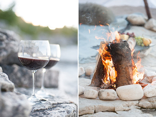 Red wine glasses and a warm campfire on the rocks