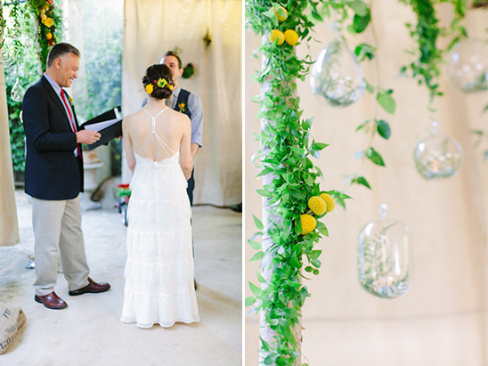 Bride at whimsical outdoor wedding ceremony with greenery