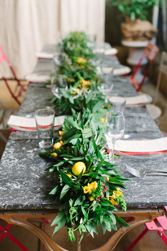 Table setting with lemons and floral garland decor