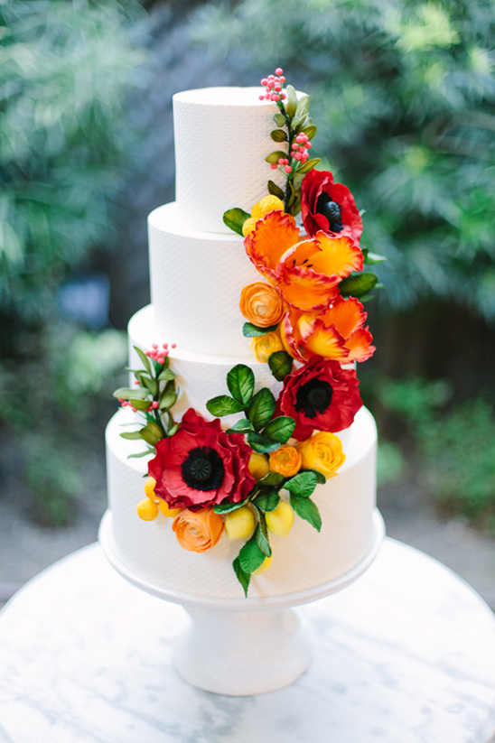 white wedding cake with bold flowers @weddingchicks