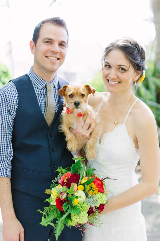 Bride groom and dog at wedding with floral bouquet