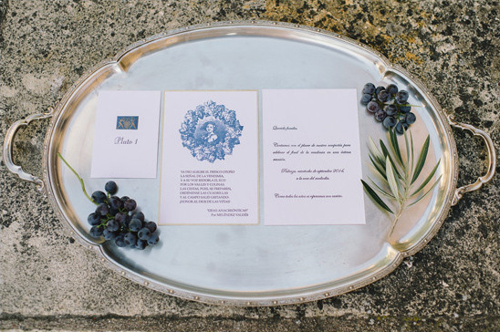 Elegant wedding invitation cards and grapes on a silver tray