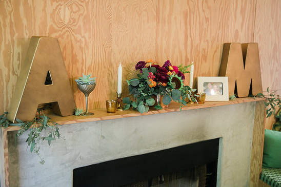Mantel with initials flowers and decor in a cozy living room