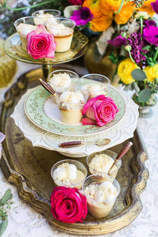 Desserts with pink roses on a decorative tray and floral arrangement