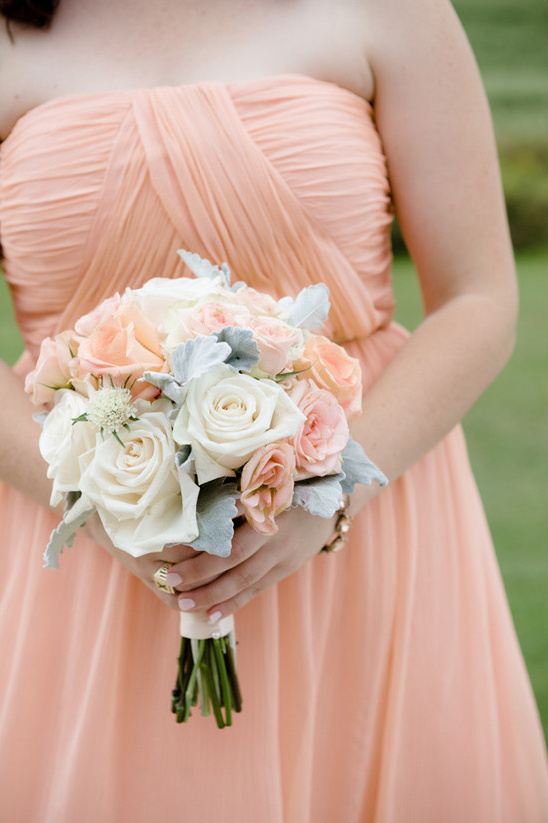 Bride holding a bouquet of roses at a wedding ceremony