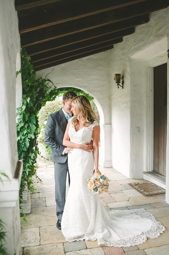 Elegant bride and groom embracing on a wedding day in a charming location