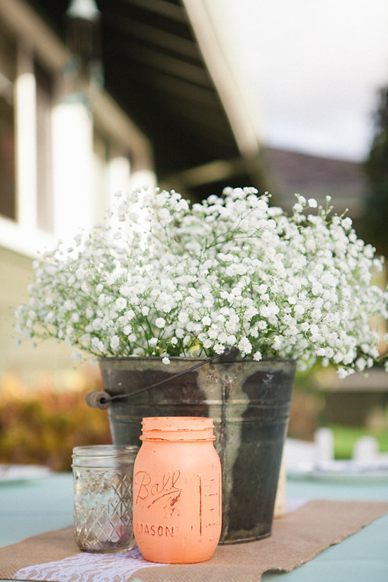 Rustic wedding centerpiece with flowers and mason jars