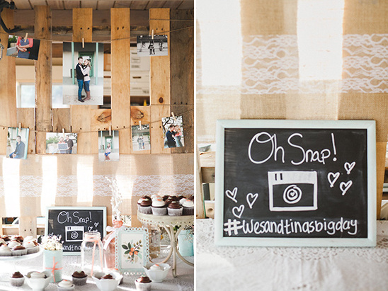 Rustic wedding decor with photos, chalkboard sign and cupcakes