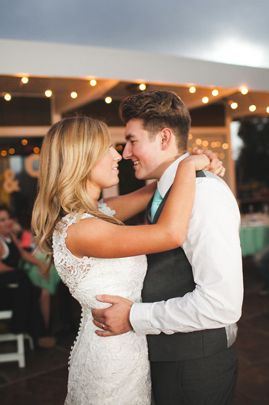 Newlywed couple sharing a romantic moment, eyes locked, at wedding